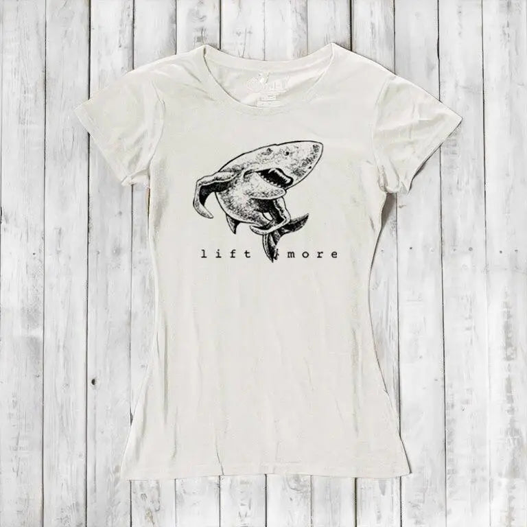 Natural white bamboo and organic cotton women's T-shirt featuring a shark and 'Lift More' text. Sustainable workout wear for lifters.