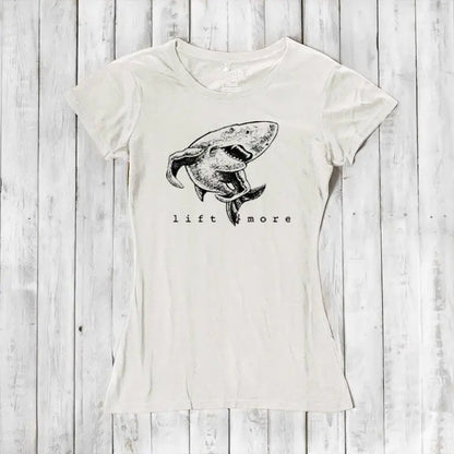 Natural white bamboo and organic cotton women's T-shirt featuring a shark and 'Lift More' text. Sustainable workout wear for lifters.