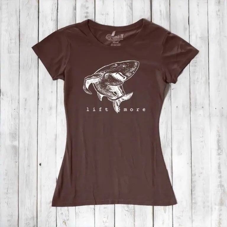 Brown eco-friendly women's T-shirt with shark and 'Lift More' graphic. Bamboo and organic cotton blend for gym and casual wear.