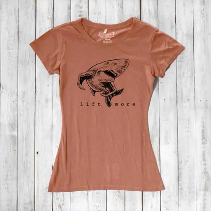 Terracotta women's T-shirt with shark and 'Lift More' graphic, made from bamboo and organic cotton. Eco-conscious gym apparel.