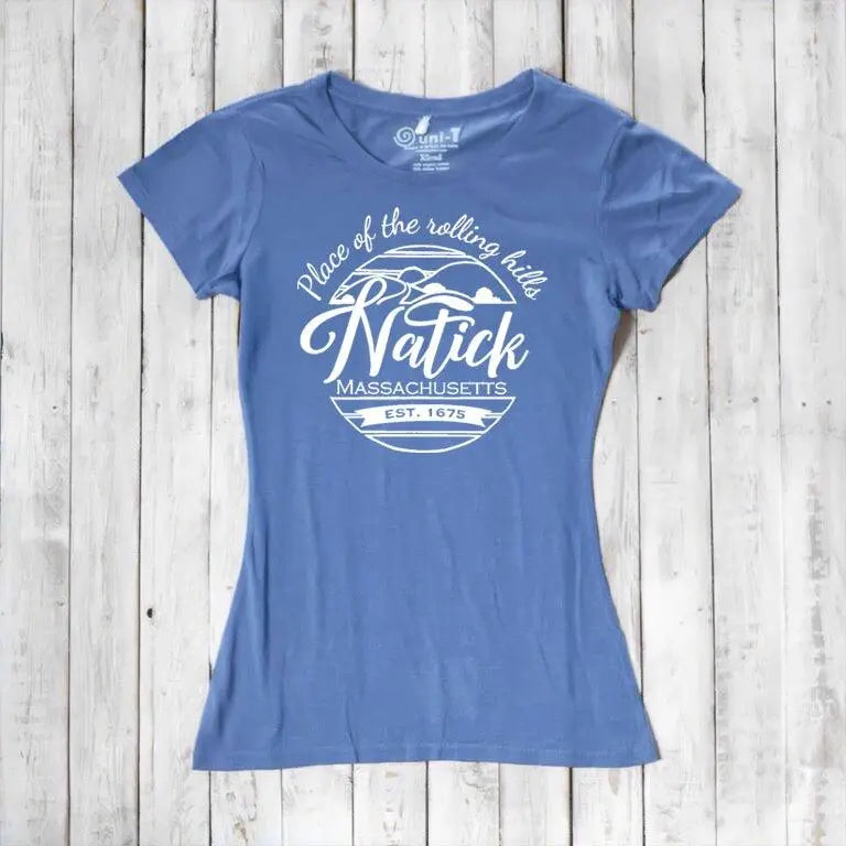 Sky blue Natick T-Shirt for women made from bamboo and organic cotton, showcasing 'Place of the Rolling Hills' Massachusetts hometown pride graphic. Sustainable gift idea.