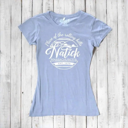 Light blue bamboo and organic cotton Natick T-Shirt for women with 'Place of the Rolling Hills' Massachusetts design. Sustainable and soft local townie tee.