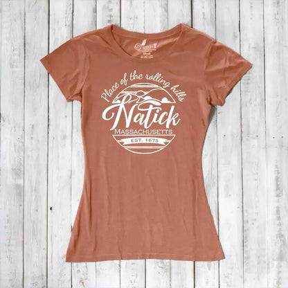 Rust-colored women's Natick T-Shirt made from bamboo and organic cotton with 'Place of the Rolling Hills' Massachusetts graphic. Eco-conscious hometown apparel.