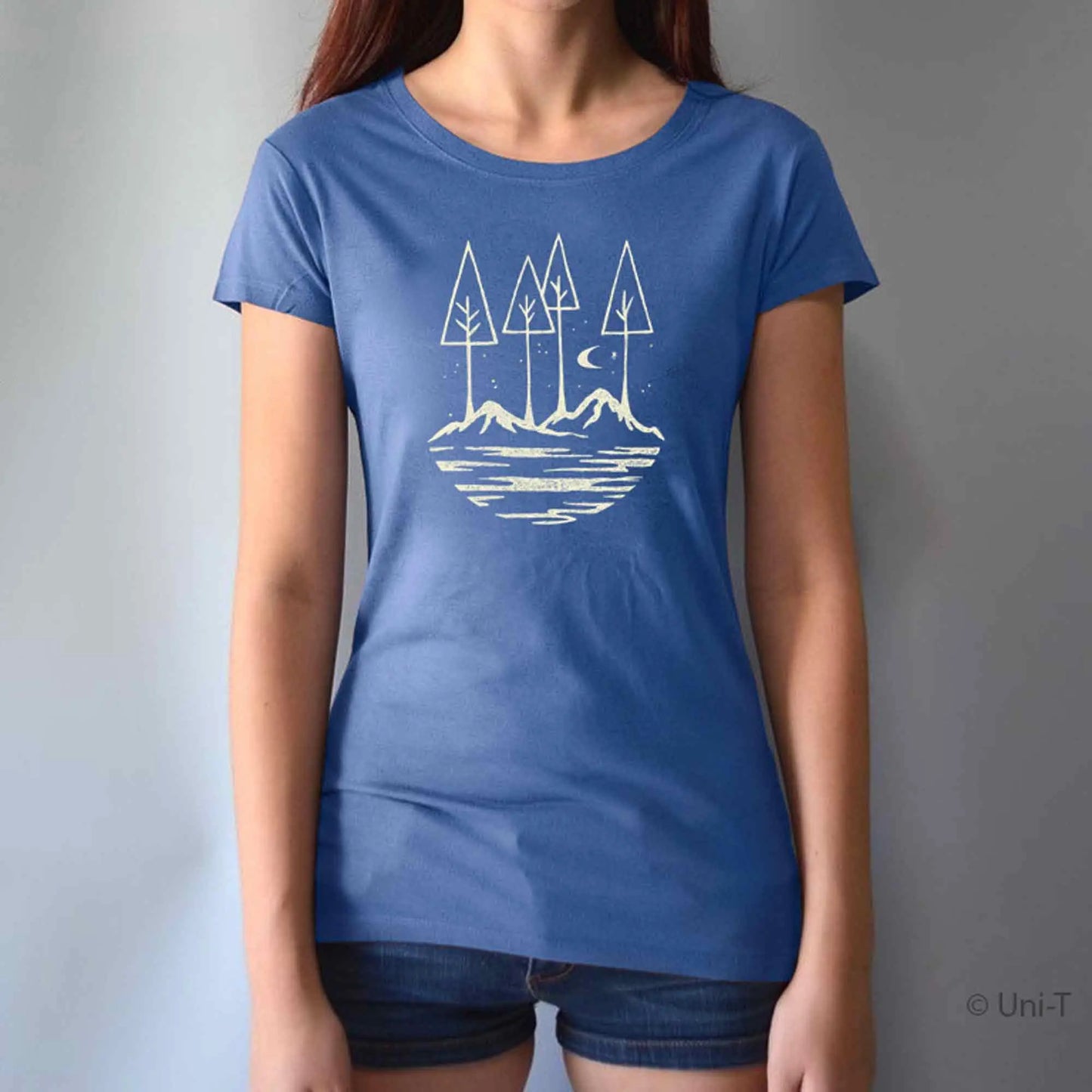 Blue bamboo and organic cotton women's t-shirt featuring a scenic forest and mountain print. Soft, breathable eco-conscious apparel for adventurers.