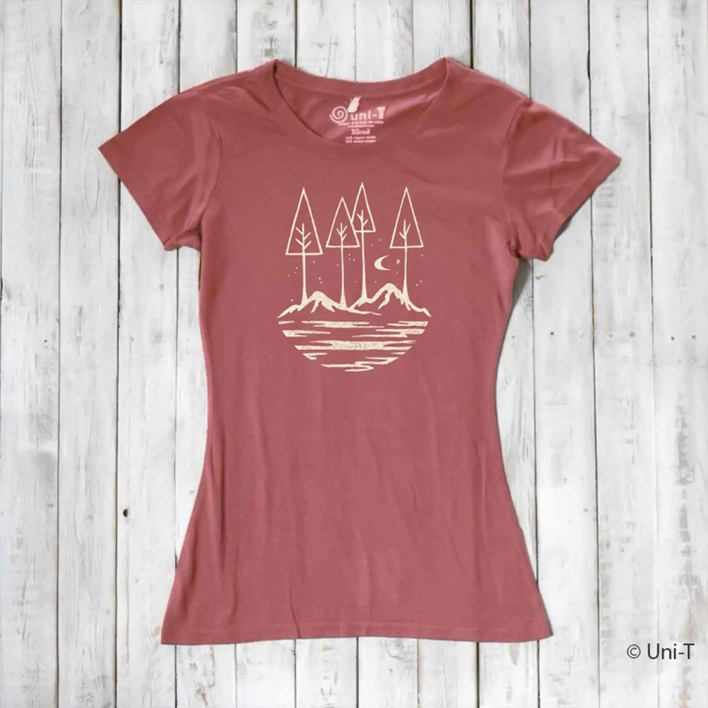 Rust red women's nature lover t-shirt made from bamboo and organic cotton. Features serene mountain and tree graphic for outdoor enthusiasts.