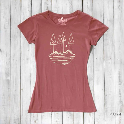 Rust red women's nature lover t-shirt made from bamboo and organic cotton. Features serene mountain and tree graphic for outdoor enthusiasts.