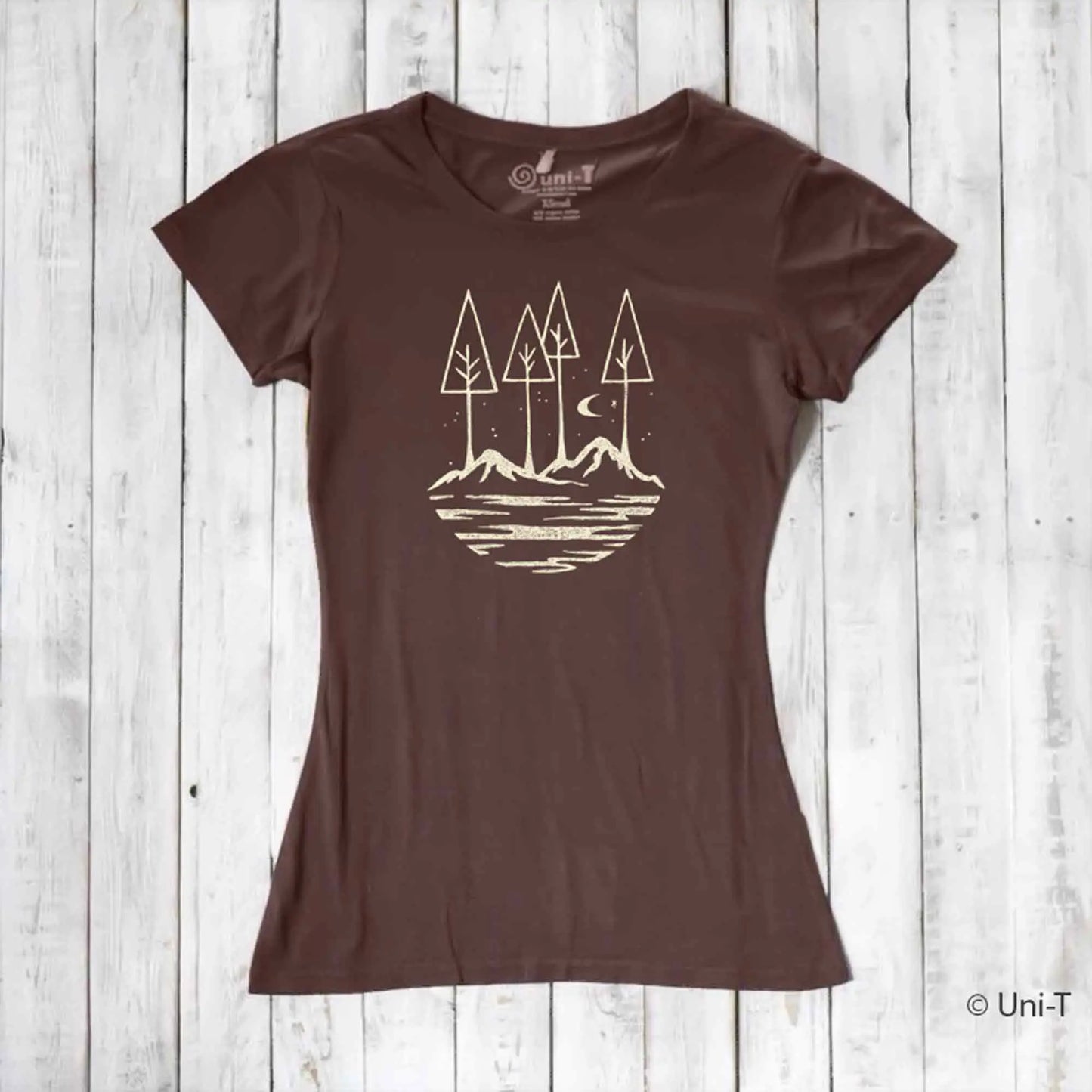Brown eco-friendly women's graphic tee with minimalist forest and mountain design. Sustainable fashion for nature lovers and hikers.