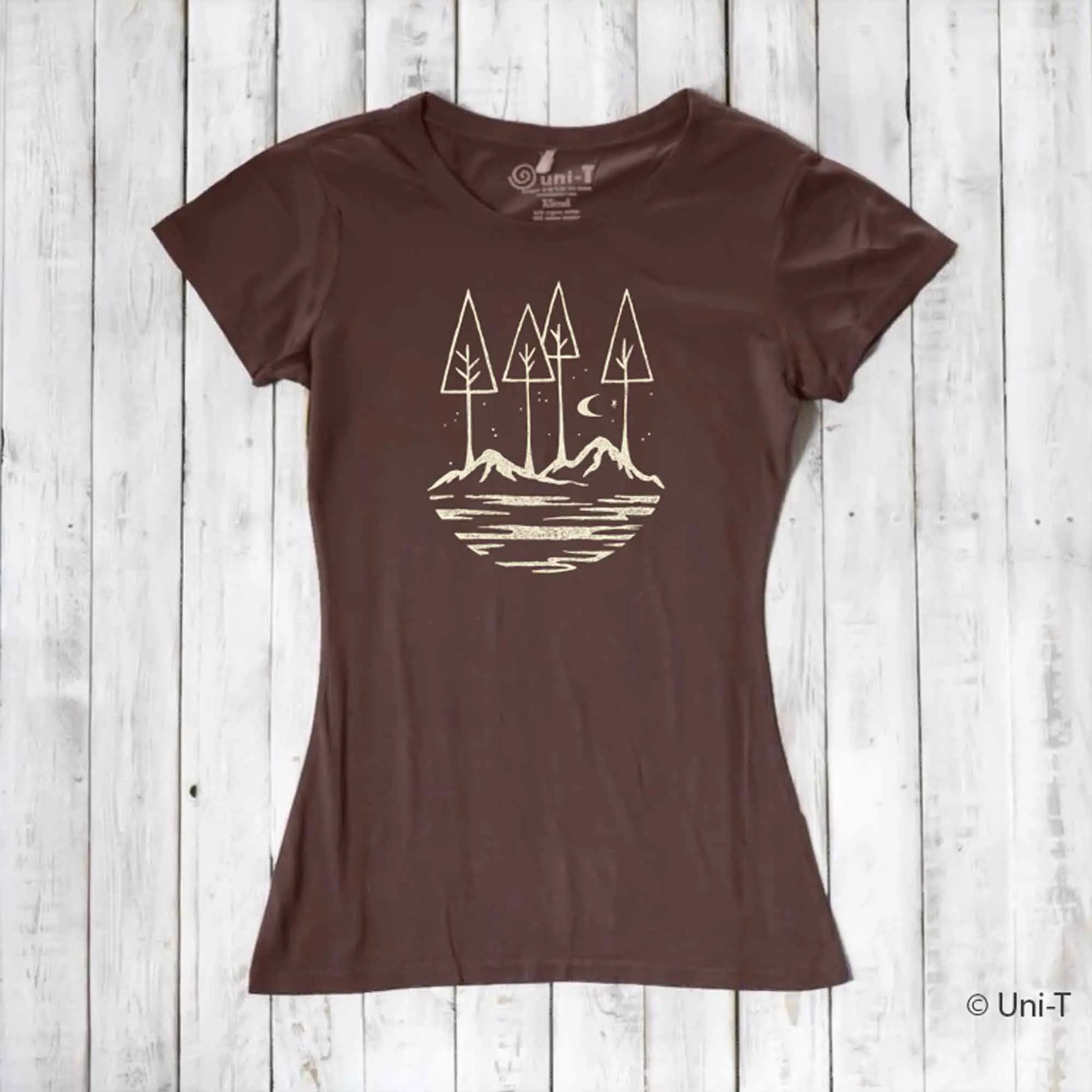 Brown eco-friendly women's graphic tee with minimalist forest and mountain design. Sustainable fashion for nature lovers and hikers.