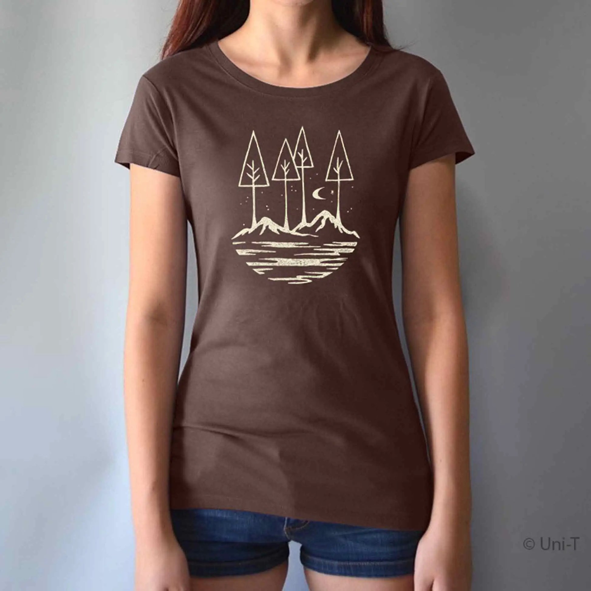 Model wearing brown bamboo and organic cotton t-shirt with forest and moon graphic. Perfect sustainable gift for outdoor-loving women.