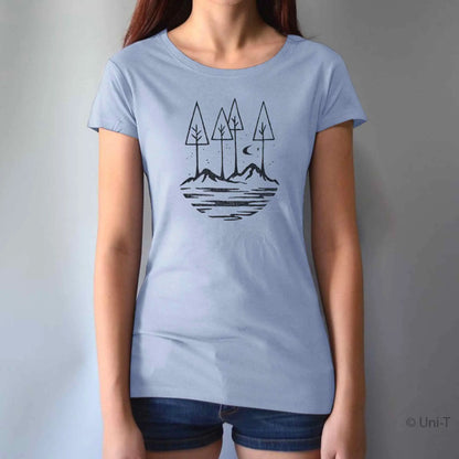 Light blue women's graphic tee with black forest and mountain illustration. Sustainable bamboo and cotton blend for nature enthusiasts.