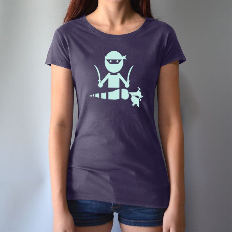 Model wearing navy 'Veggie Ninja' vegan T-shirt for women, featuring a mint green ninja and carrot graphic on sustainable fabric.