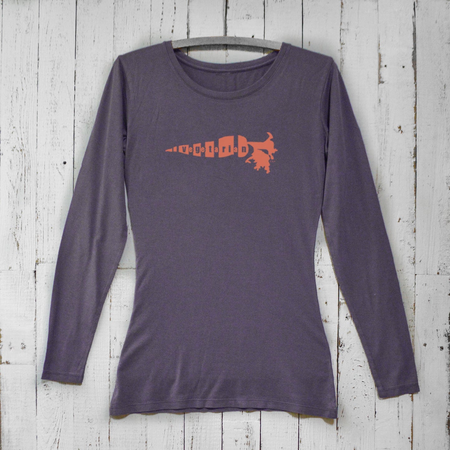 Dark purple vegetarian long sleeve t-shirt for women featuring orange carrot print. Sustainable bamboo organic cotton top for veggie lovers.