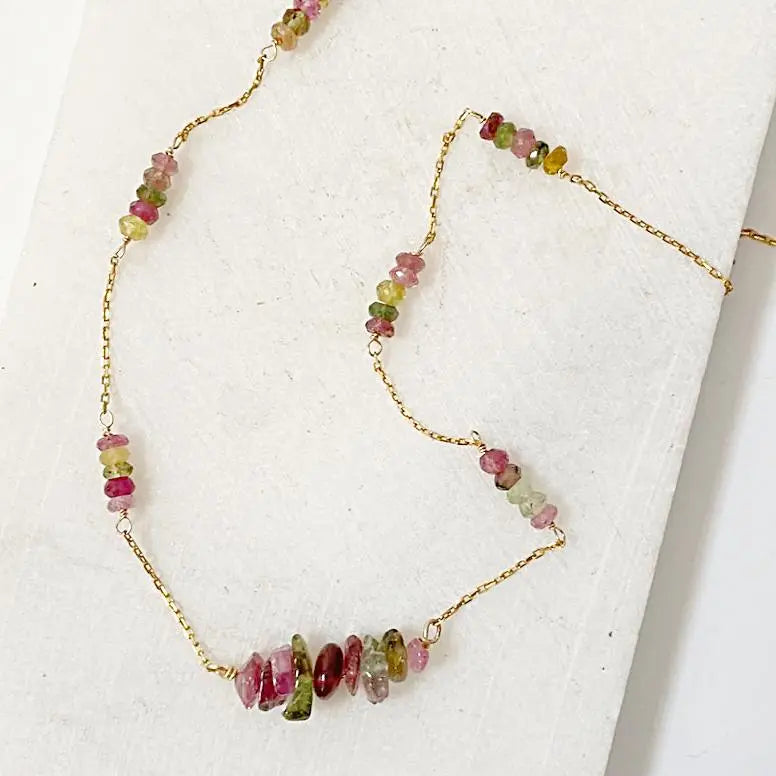Detail of Floating Watermelon Tourmaline Necklace with polished gemstone beads in pink and green hues on a dainty gold-filled chain.