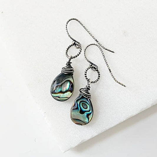 Rainbow Wire Wrapped Earrings with sterling silver teardrop shell beads and antiqued silver wire, displayed on a white background.