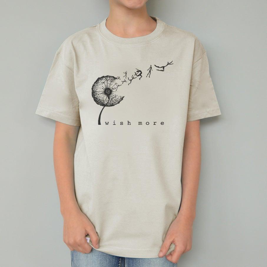 Beige Kids' Dandelion Organic Cotton T-Shirt worn by child, featuring black 'Wish More' graphic, sustainable top by Uni-T.