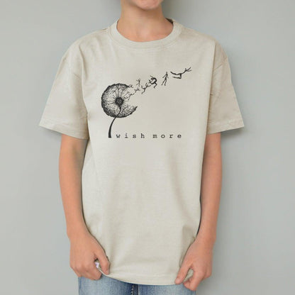 Beige Kids' Dandelion Organic Cotton T-Shirt worn by child, featuring black 'Wish More' graphic, sustainable top by Uni-T.