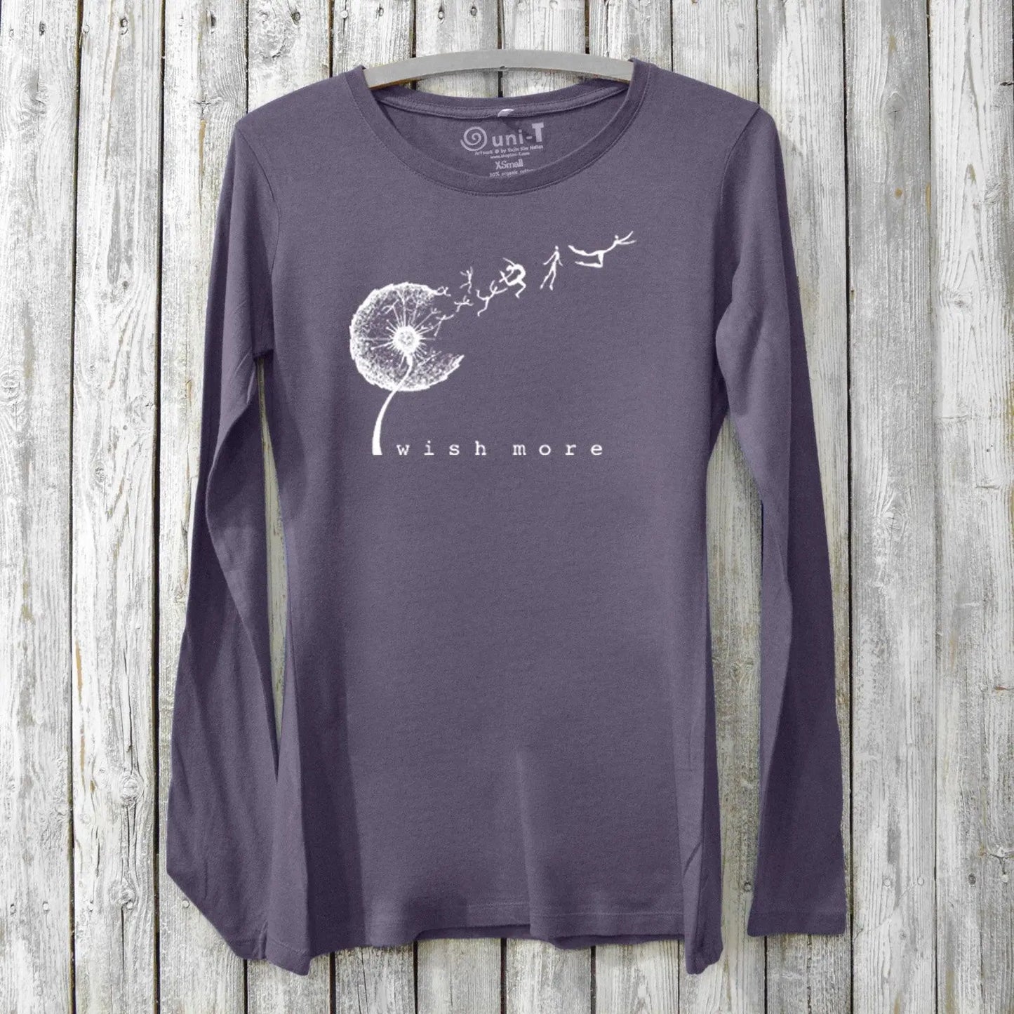 Purple bamboo and organic cotton women's long sleeve tee featuring a white dandelion 'Wish More' design, perfect for mindful fashion lovers.