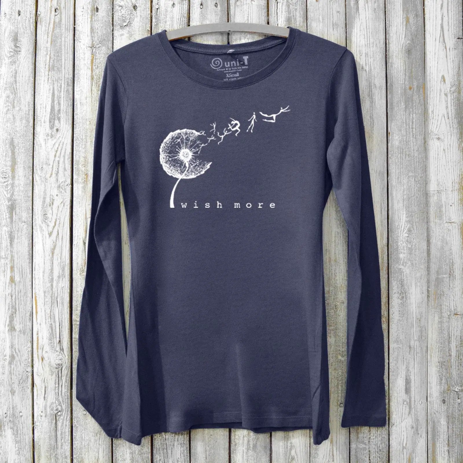 Navy blue women's long sleeve t-shirt made from bamboo and organic cotton, showcasing a white dandelion 'Wish More' graphic for hopeful, sustainable style.