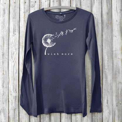 Navy blue women's long sleeve t-shirt made from bamboo and organic cotton, showcasing a white dandelion 'Wish More' graphic for hopeful, sustainable style.