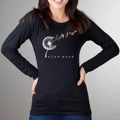 Model wearing black 'Wish More' dandelion long sleeve tee made from bamboo and organic cotton, a sustainable and motivational gift for women.