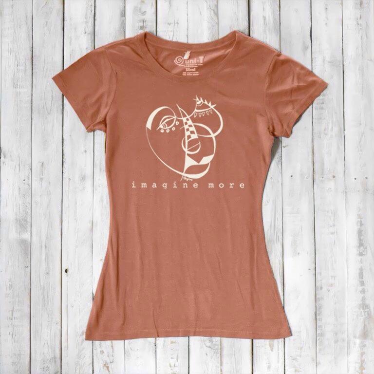 Women's Cubism Face T-Shirt in terracotta bamboo & organic cotton with white abstract face and 'imagine more' text. Eco-conscious art-inspired tee.
