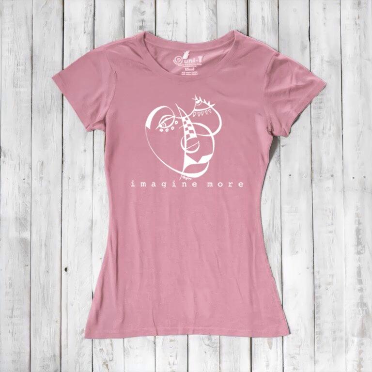 Pink Women's Cubism Face T-Shirt in bamboo & organic cotton with white abstract face and 'imagine more' text. Soft, sustainable gift for artists.