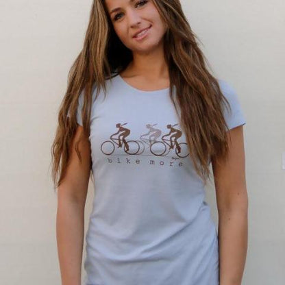 Model in light blue Women's Bicycle T-Shirt in Bamboo & Organic Cotton with 'Bike More' print, perfect for casual wear and cycling enthusiasts.