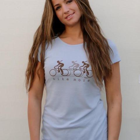 Model in light blue Women's Bicycle T-Shirt in Bamboo & Organic Cotton with 'Bike More' print, perfect for casual wear and cycling enthusiasts.