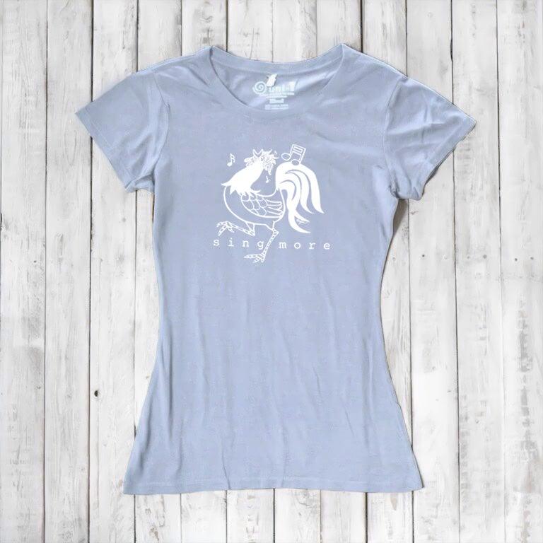 Light blue women's rooster t-shirt with 'Sing More' message, made from eco-friendly bamboo and organic cotton materials.
