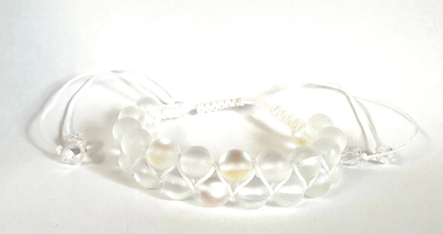 Adjustable woven bead bracelet with frosted white glass beads and white nylon cord. Elegant and versatile for everyday wear.