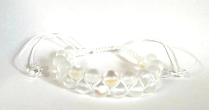 Adjustable woven bead bracelet with frosted white glass beads and white nylon cord. Elegant and versatile for everyday wear.