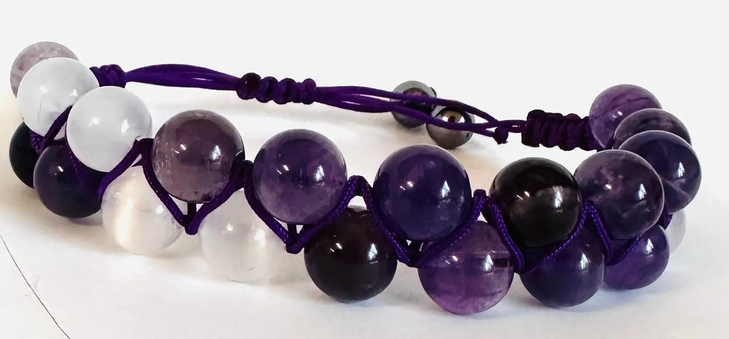 Purple and white gemstone woven bead bracelet with adjustable purple nylon cord. Ideal for fashion-forward, spiritual styles.